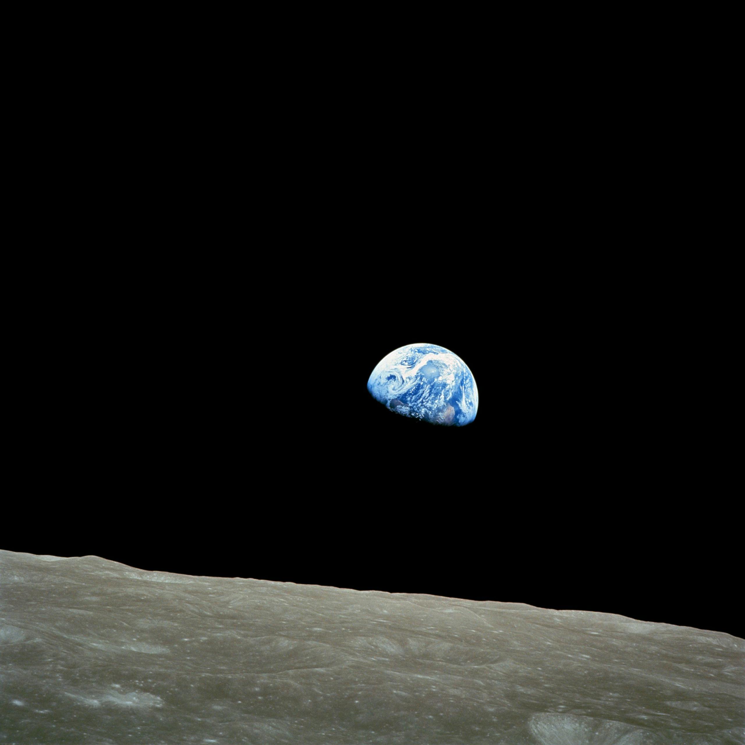Iconic view of Earth rising over the lunar surface in space, capturing celestial beauty.