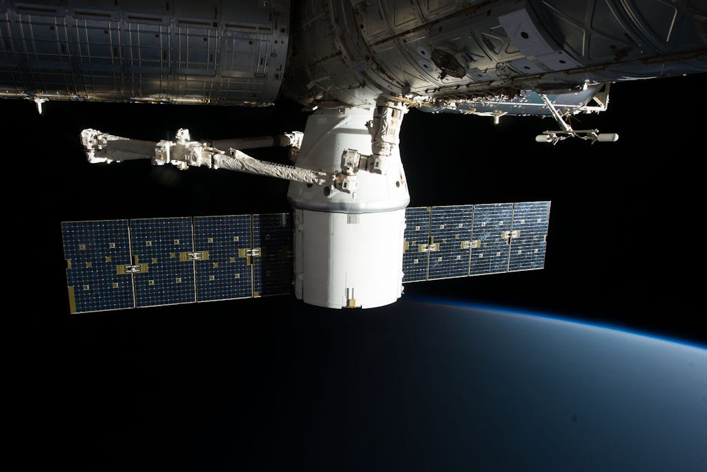 Image of the International Space Station floating above Earth with visible solar panels.