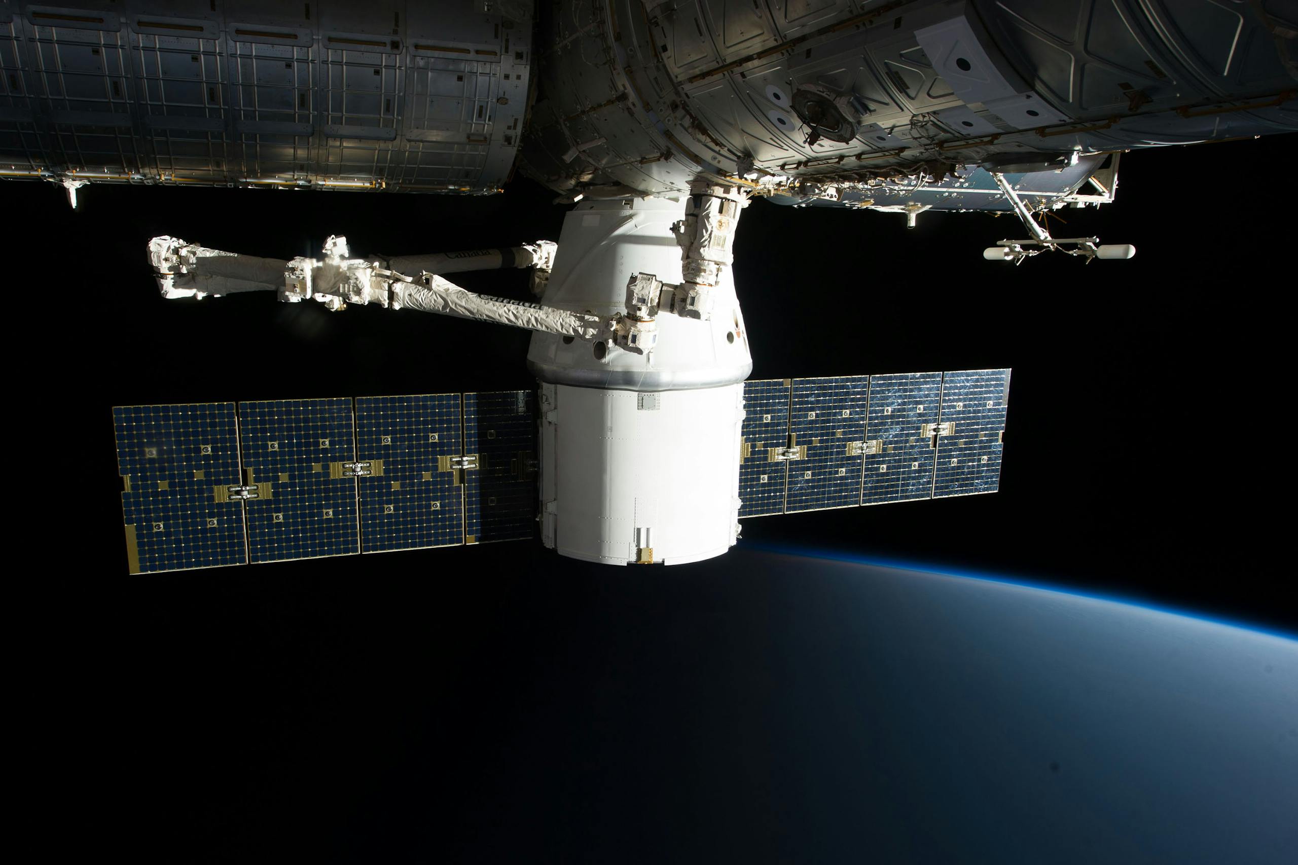 Image of the International Space Station floating above Earth with visible solar panels.